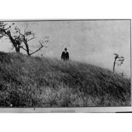 Man Standing on a Hillside
