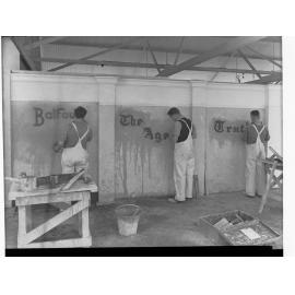 Sign writers showing three men doing different signs - BALFOURS, THE AGE, TRUTH signs