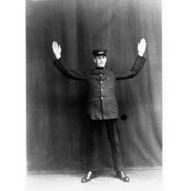 Porter demonstrating railway hand signals