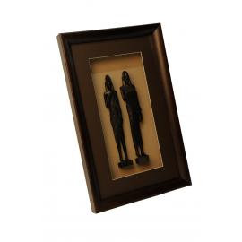 Two carved statuettes in frame